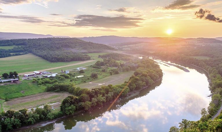 The sun sets over the Susquehanna River and the Terry Township's rolling farmland in northern Pennsylvania.