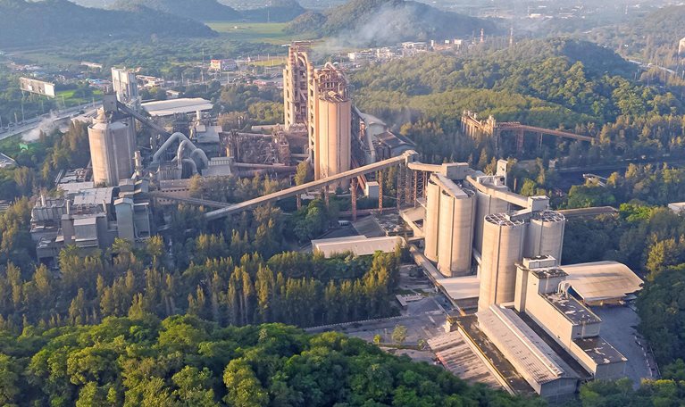 Aerial view, Golden hour cement plant business construction industrial in valley.