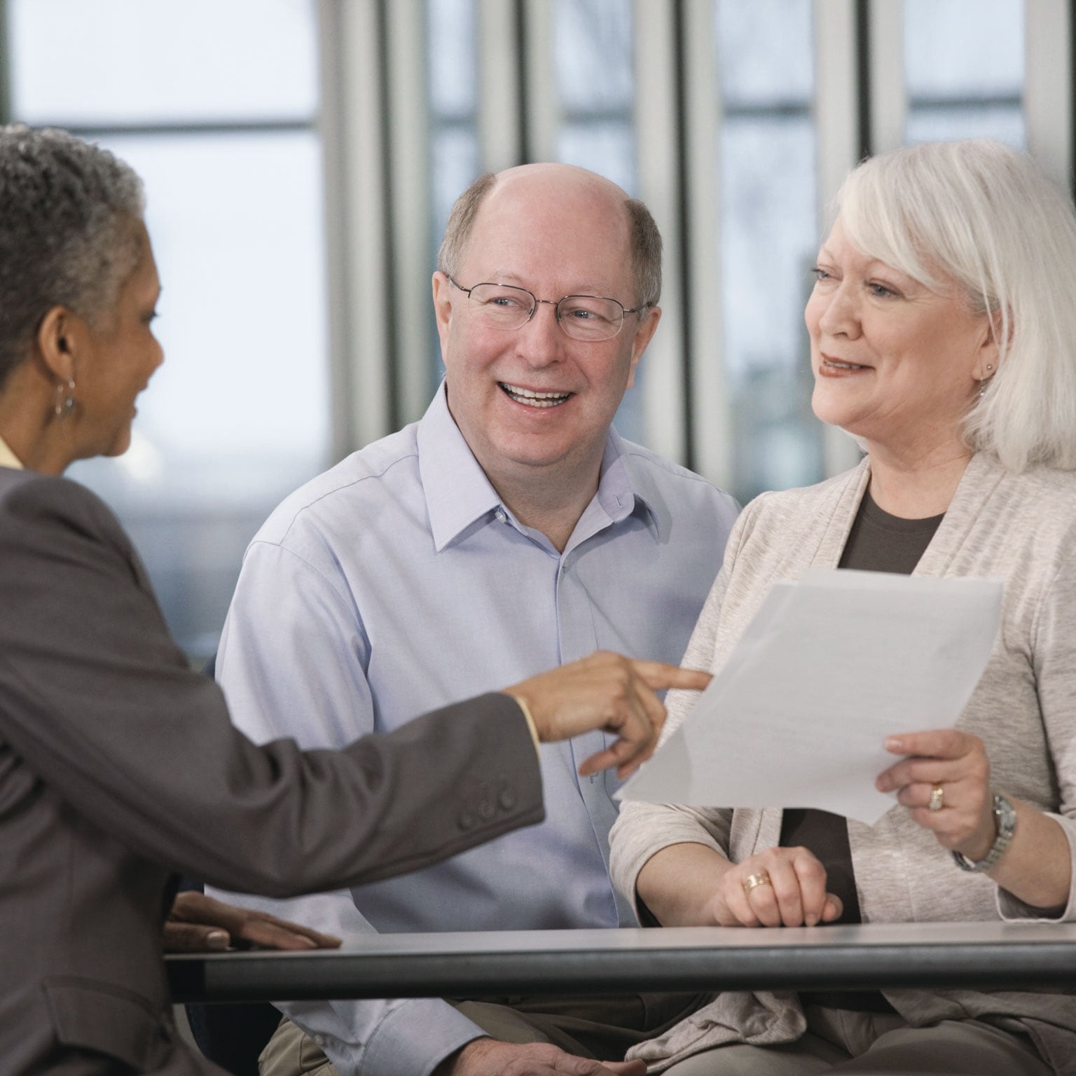 Senior couple talking with financial advisor