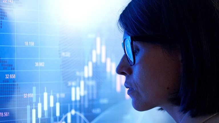 Profile of a business woman against the background of an investment chart