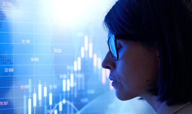 Profile of a business woman against the background of an investment chart