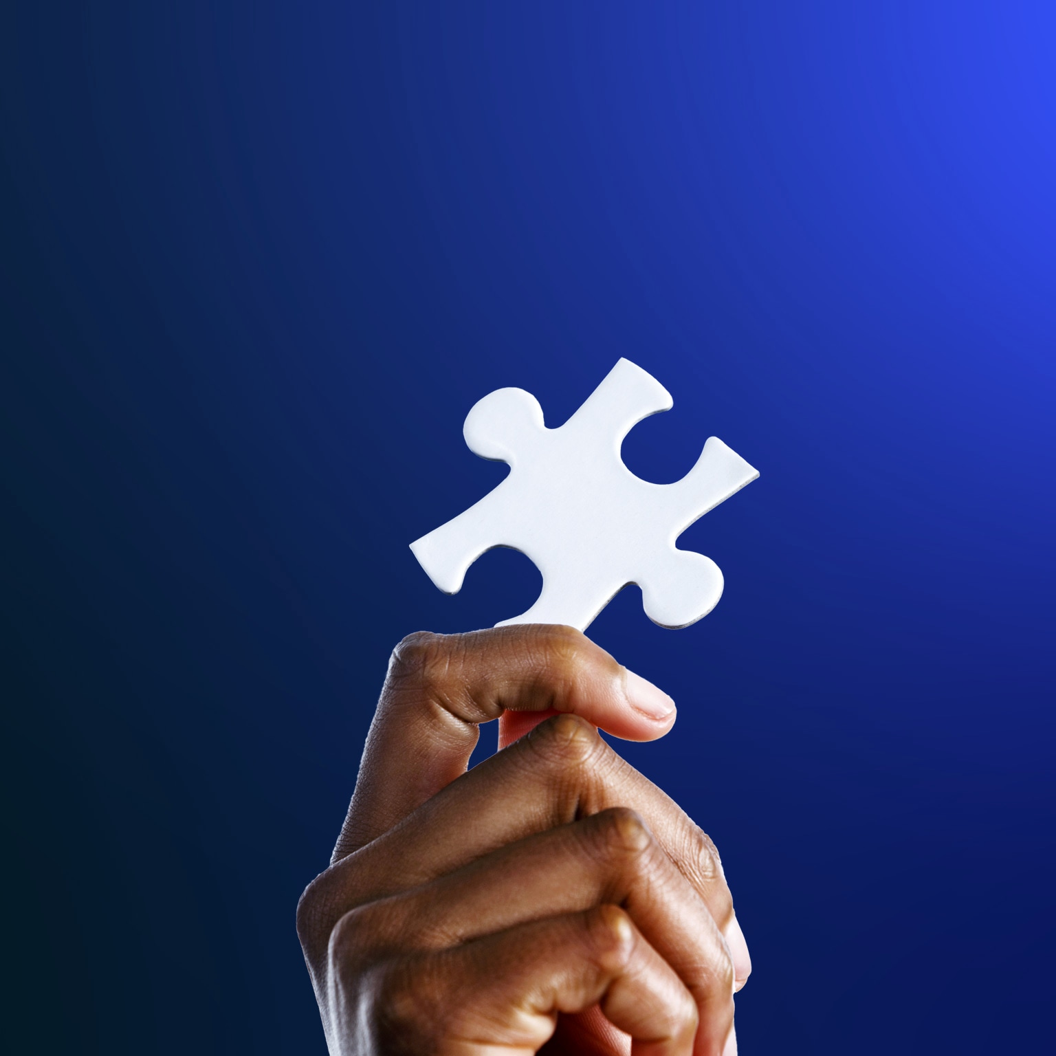 Hand holding a jigsaw puzzle