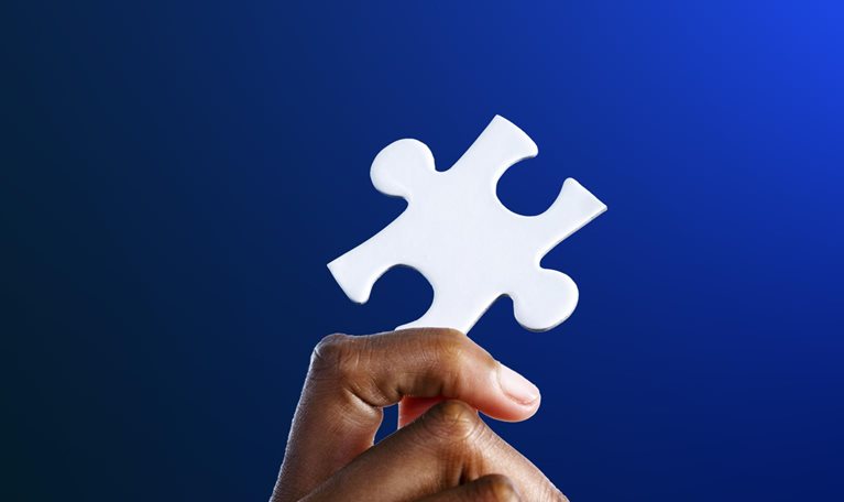 Hand holding a jigsaw puzzle