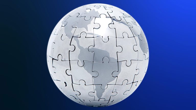 Silver 3D globe puzzle centering on South America