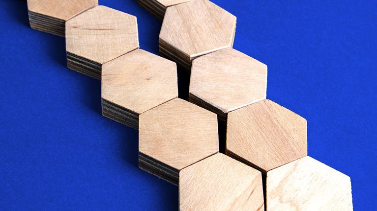 Two separate chains of wooden blocks converge to form a single chain.