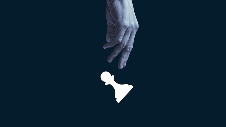 Human hand throwing white pawn. - stock photo