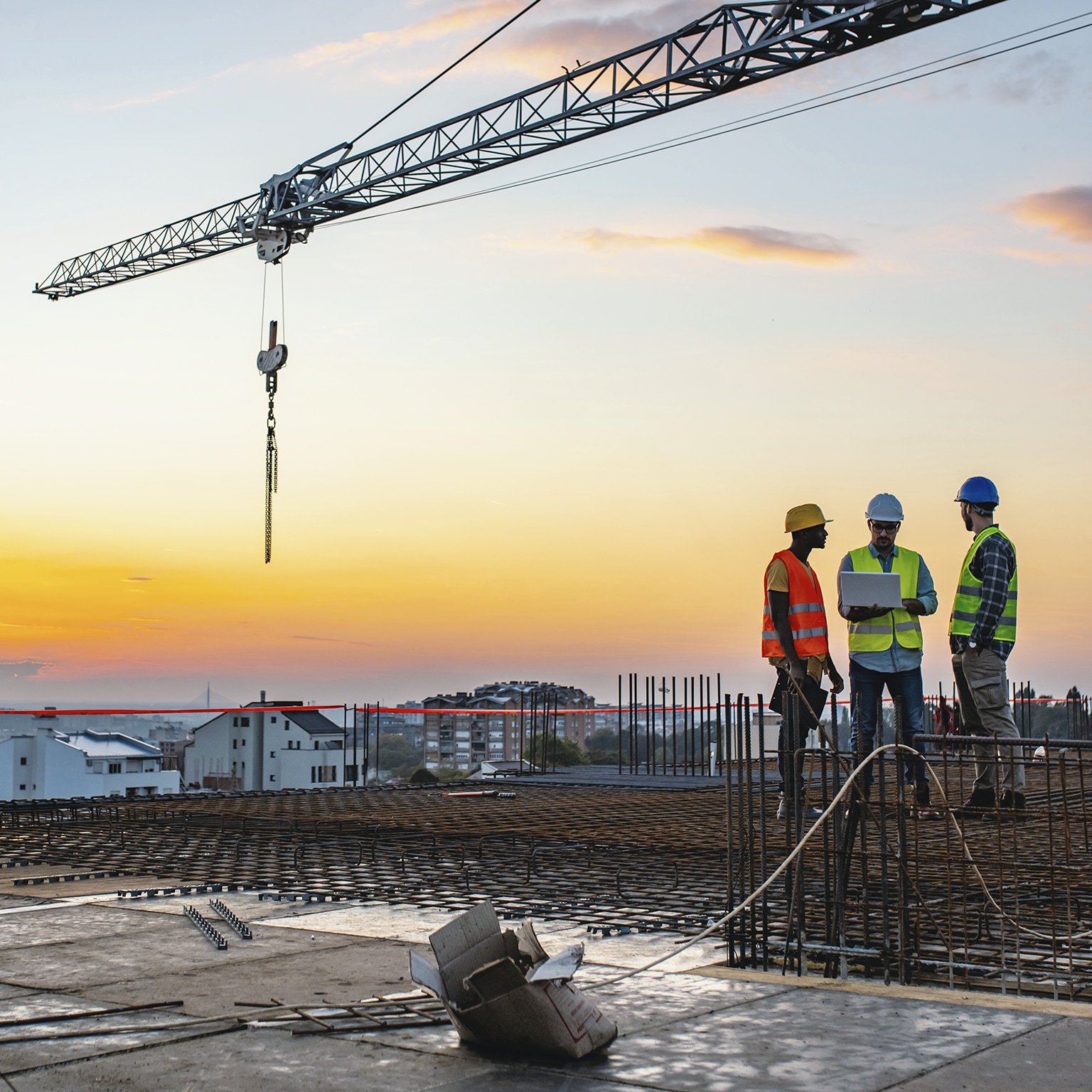 Construction workers atop building