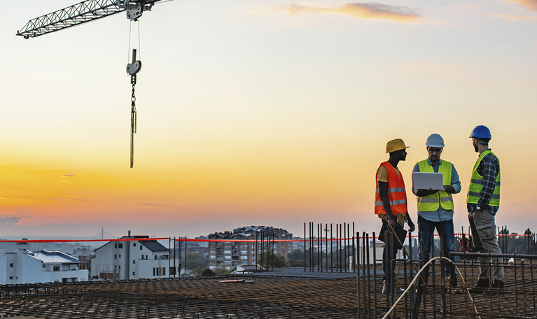 Construction workers atop building
