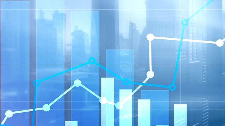 A collage of charts and graphs over a city skyline