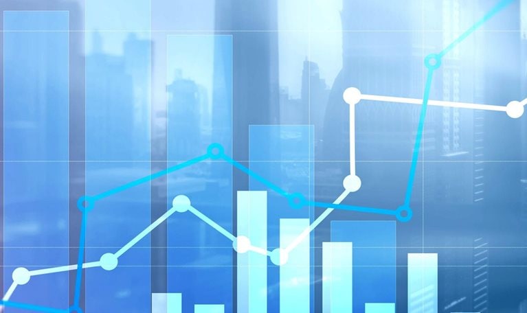 A collage of charts and graphs over a city skyline