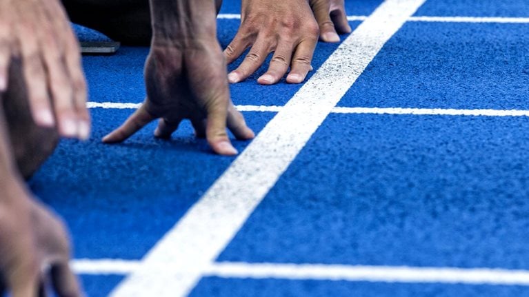 Track runners in position at the starting line of a race.