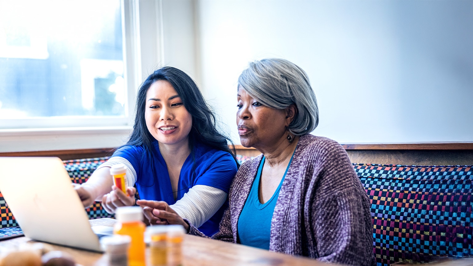  Senior woman having in-home consultation with nurse
