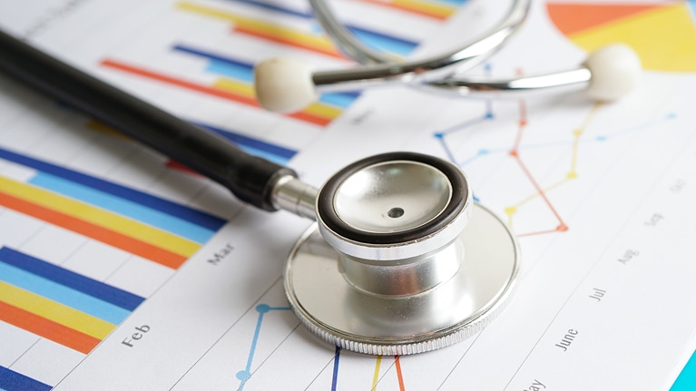 Stethoscope placed on charts of graph paper