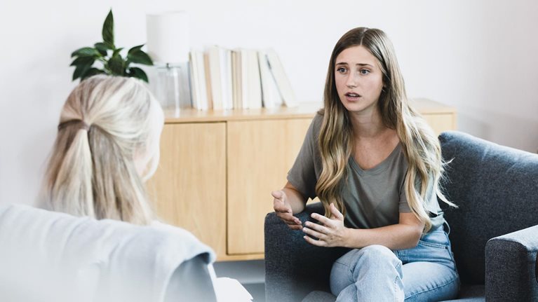 Young woman talks with therapist