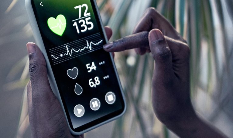 Woman checking pulse trace through mobile phone at home