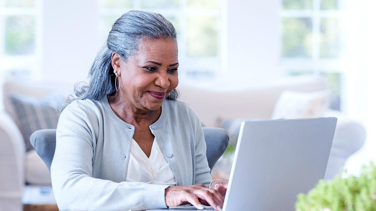 An elderly lady accessing healthcare online with ease