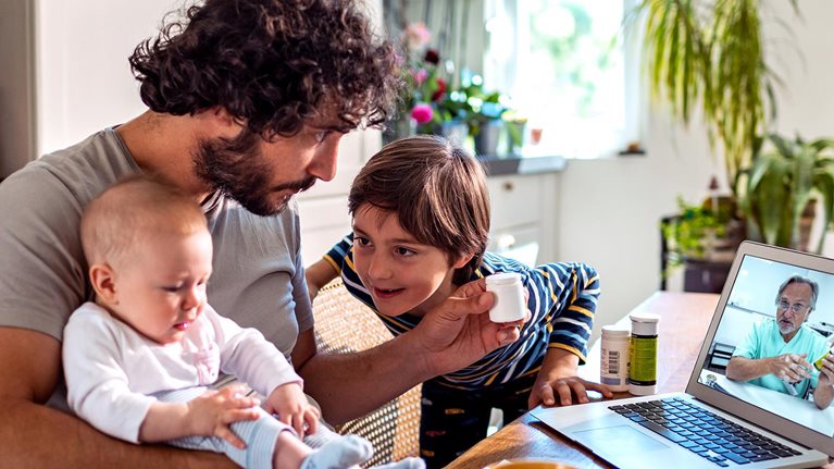 Father with two young children consulting doctor online