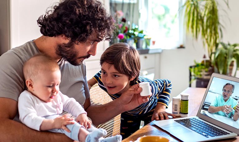 Father with two young children consulting doctor online
