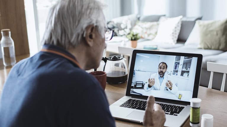Senior man consulting with a doctor on his laptop.