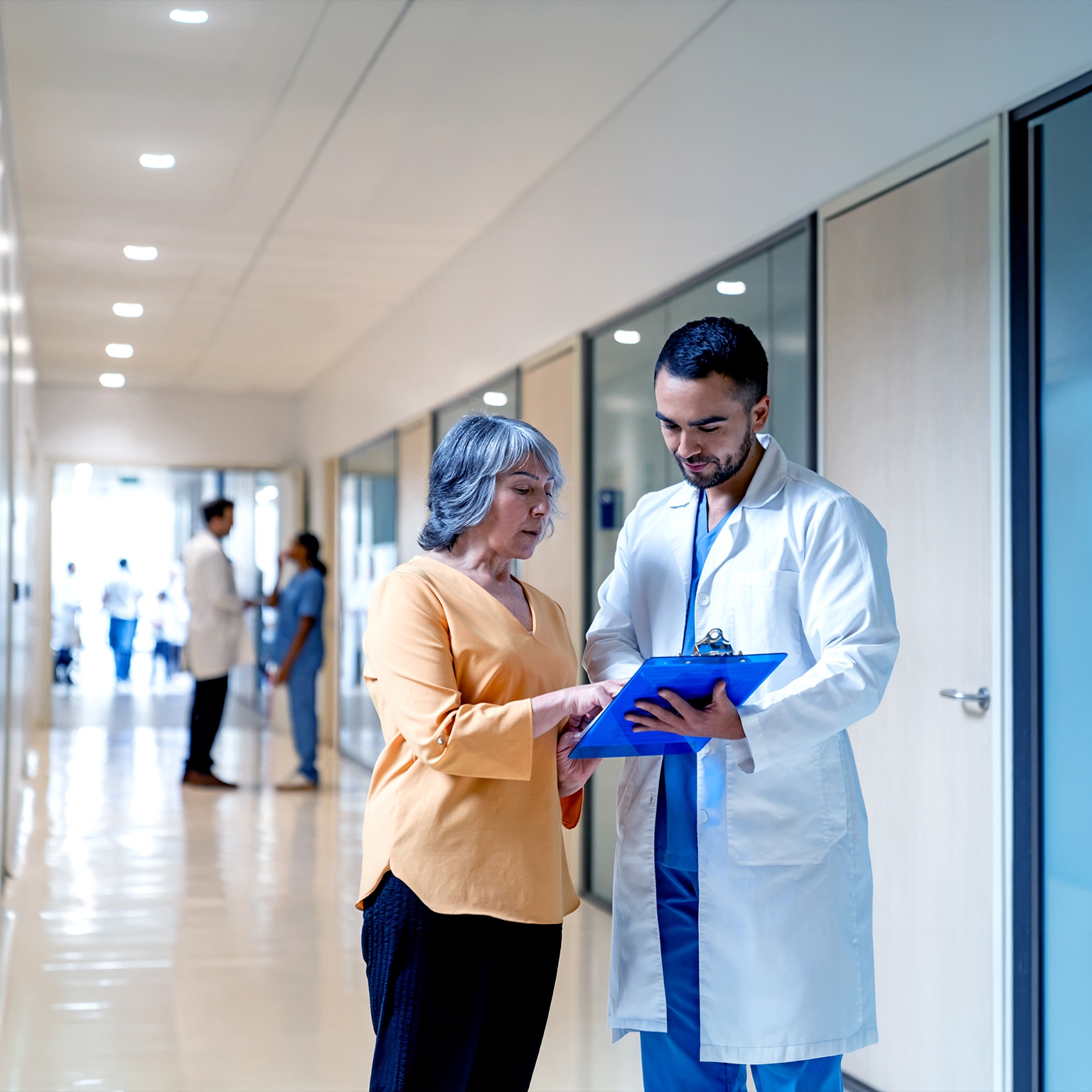 Latin American doctor explaining the test results to a senior woman at the hospital