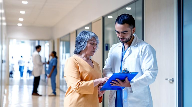 Latin American doctor explaining the test results to a senior woman at the hospital