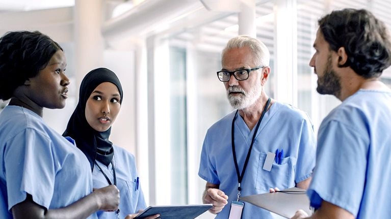 Image of a diverse group of nurses talking in a hospital.