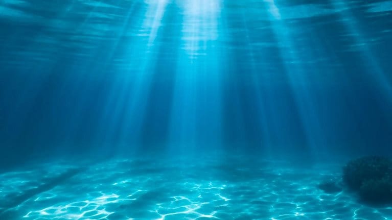 Underwater ocean. Deep sea water abyss with blue sun light from surface. - stock photo