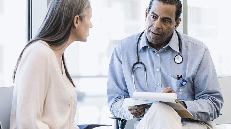Physician listens to the new staff member - stock photo