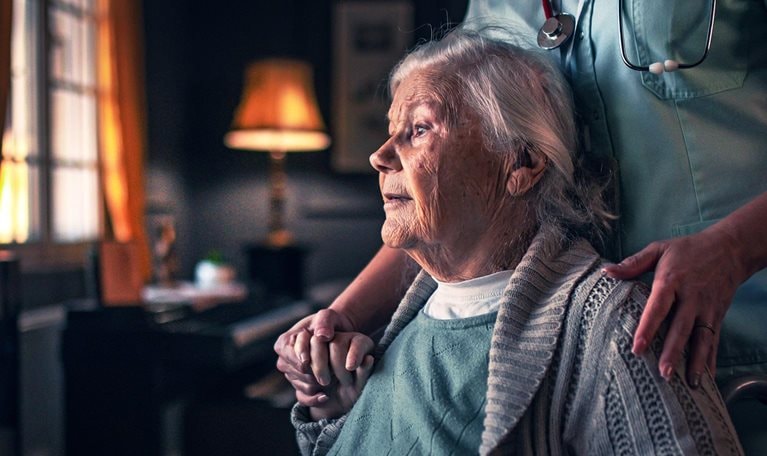 Nurse in a home visit to an elderly woman with disabilities