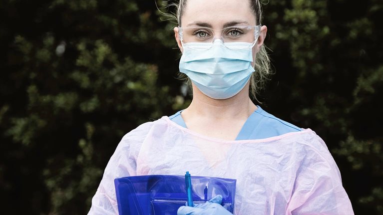 Portrait of Nurse Wearing Protective Workwear Outdoors - stock photo