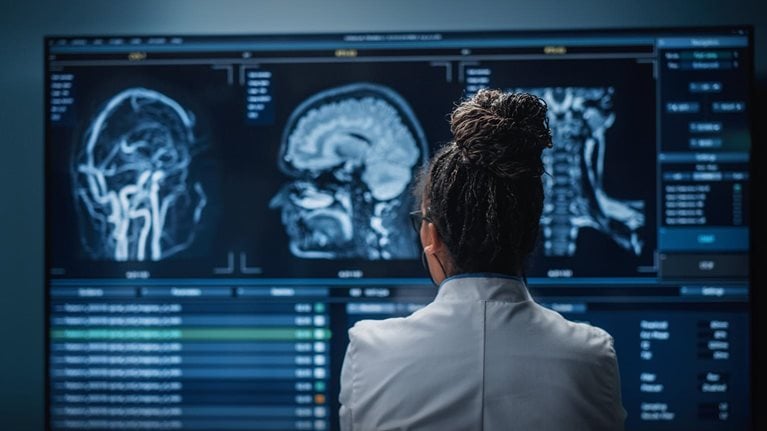 Medical Hospital Research Lab: Black Female Neuroscientist Looking at TV Screen, Analyzing Brain Scan MRI Images, Finding Treatment for Patient. Health Care Neurologist Curing People. Back View Zoom - stock photo