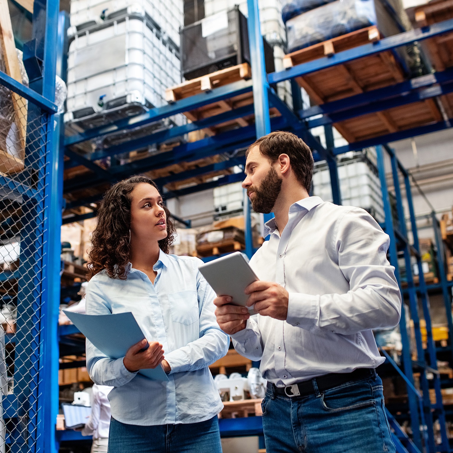 Warehouse employees checking stock levels in company warehouse. - stock photo