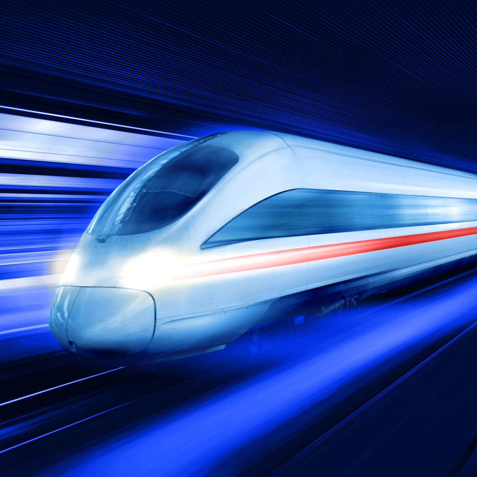 A sleek, modern high-speed train as it moves at great velocity through a dark, tunnel-like space. The motion is emphasized by the vibrant blue and white light trails that blur past the train.