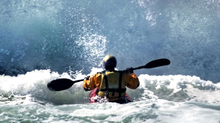 A person whitewater rafting