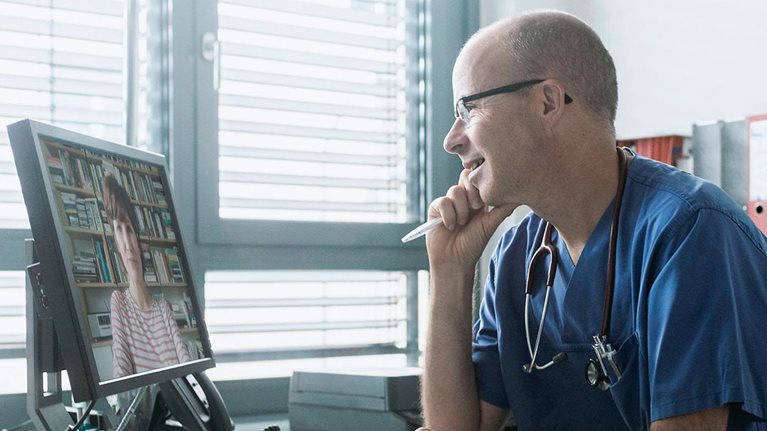 Doctor talking to woman on video call
