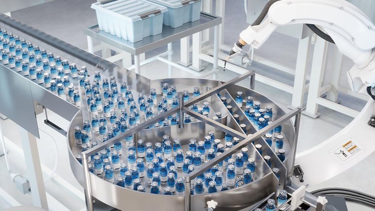 An automatic medicine manufacturing factory. Robotic arm working on medicine manufacturing production line.