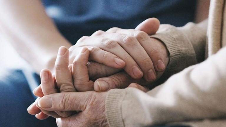 Cropped shot of a senior woman holding hands with a nurse