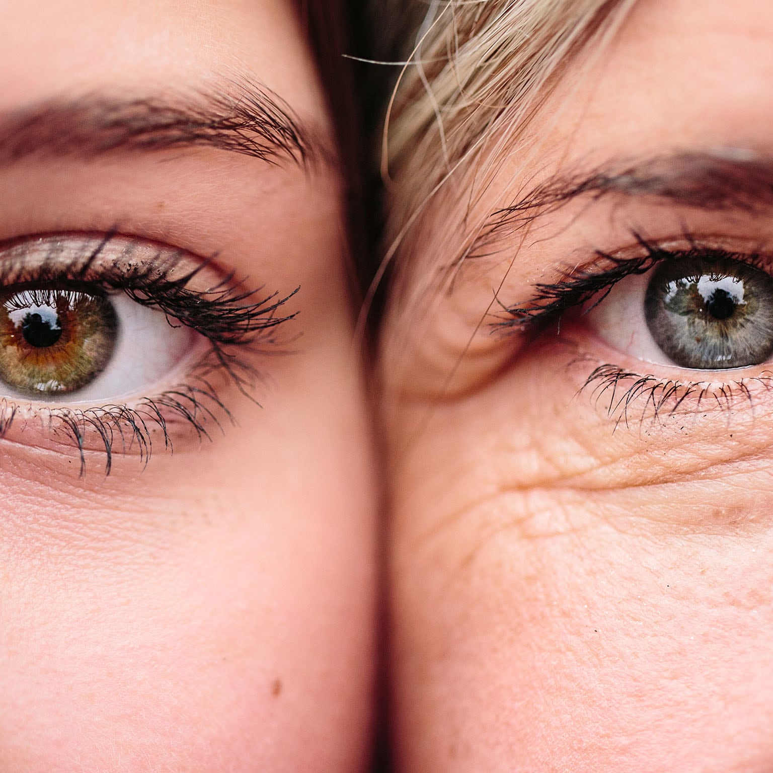 Close up on eyes of mother and daughter faces next to one another.