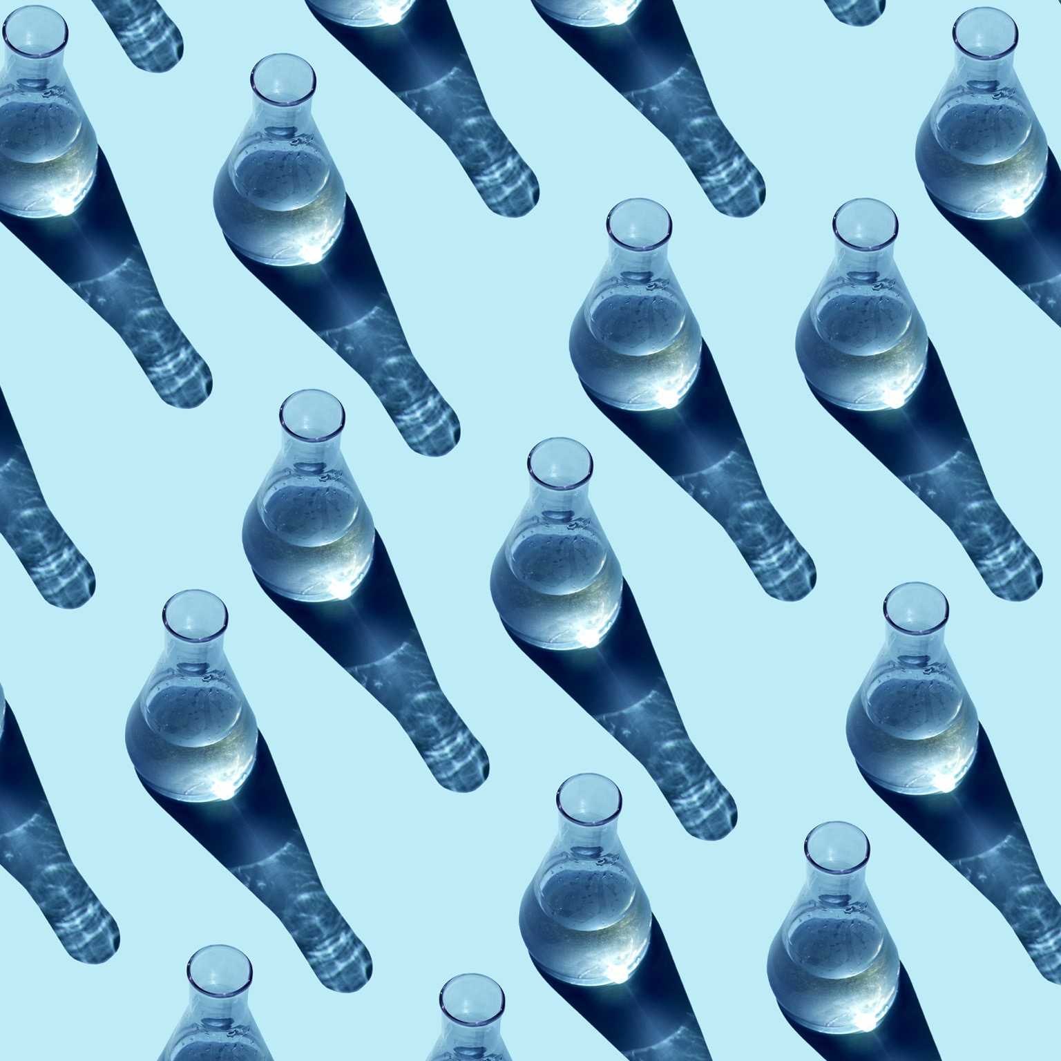 Seamless pattern made from glass beakers on a blue background