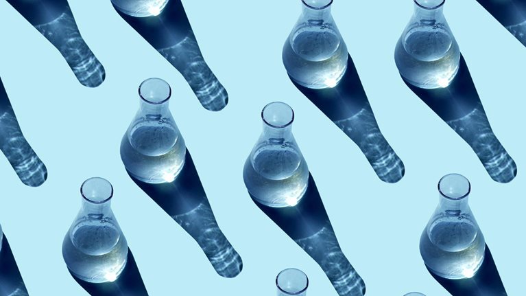 Seamless pattern made from glass beakers on a blue background.