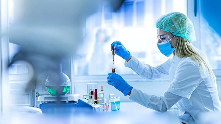 Female scientist examining toxic liquid in laboratory
