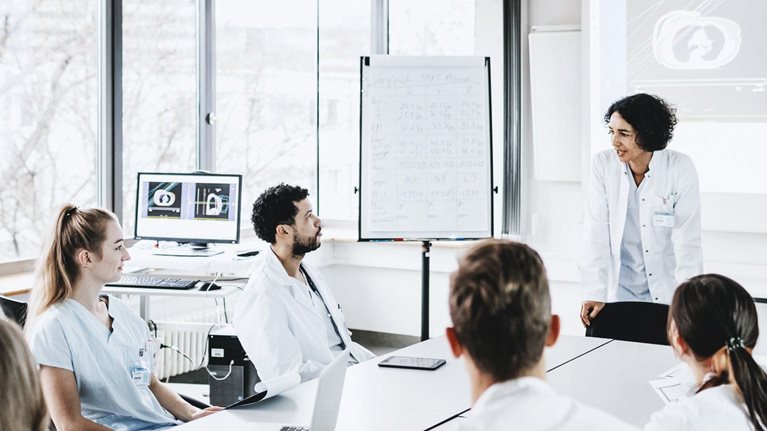 Oncologists gathered around a table.