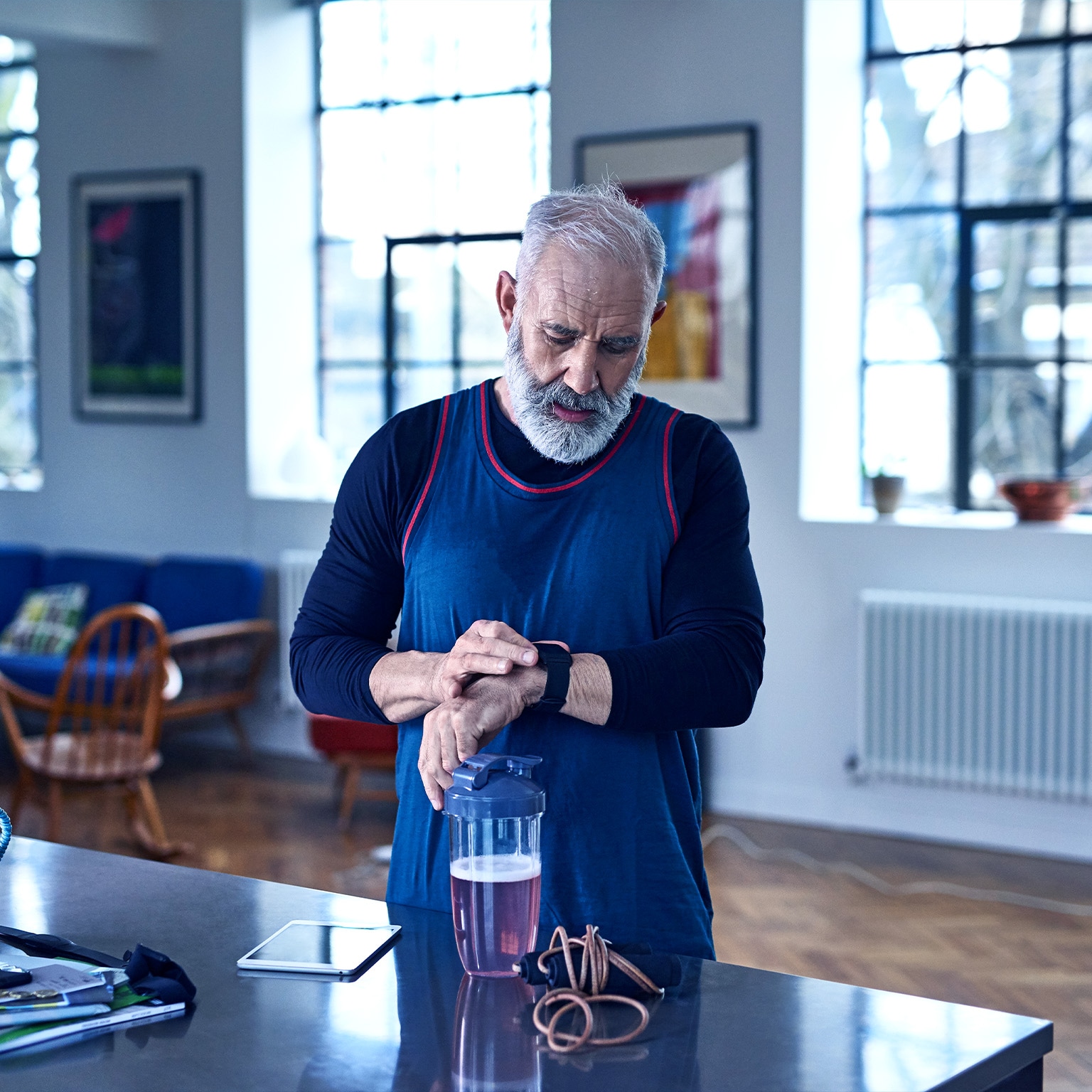 Senior man checking smart watch before exercising
