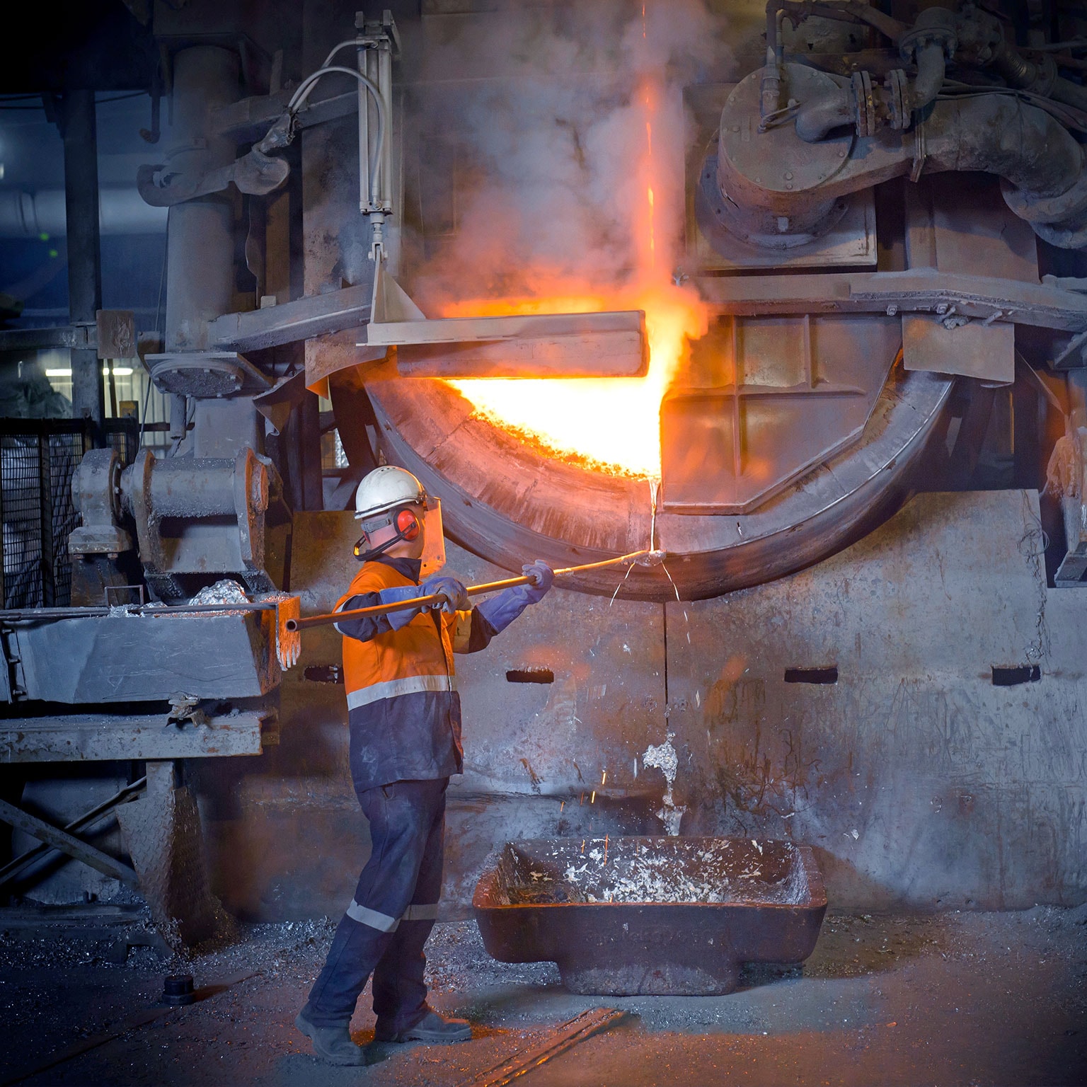 Worker handling molten aluminum