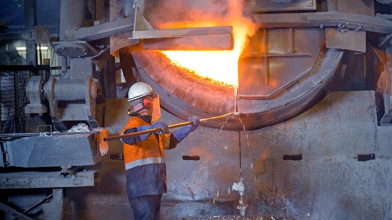 Worker handling molten aluminum