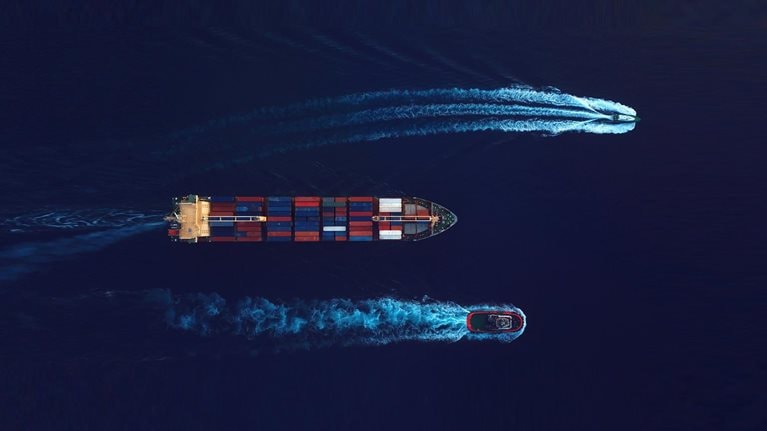 Aerial top view of cargo shipping during sunrise, import export activity. World at work drone view. - stock photo