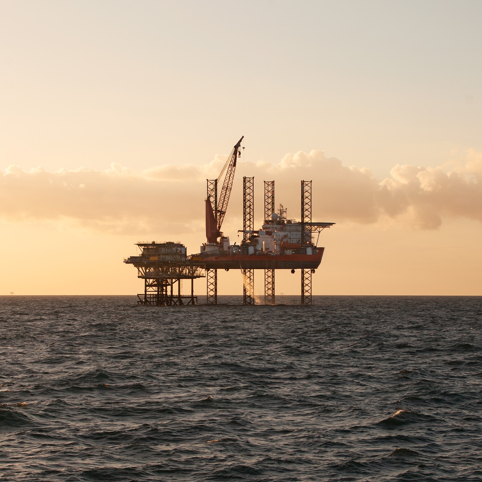 Jack Up heavy lift ship at sunset - stock photo