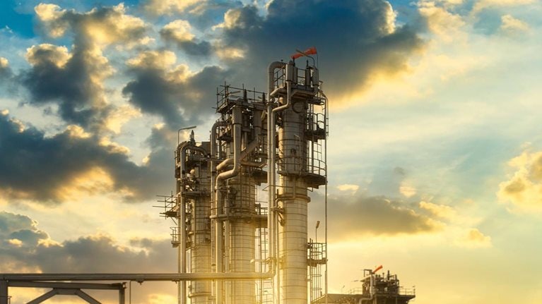 Oil refinery concept shows beautiful scenery of the oil refinery or petrochemical plant under the sunlight in the sunset time for creating the petrochemical industry background. - stock photo