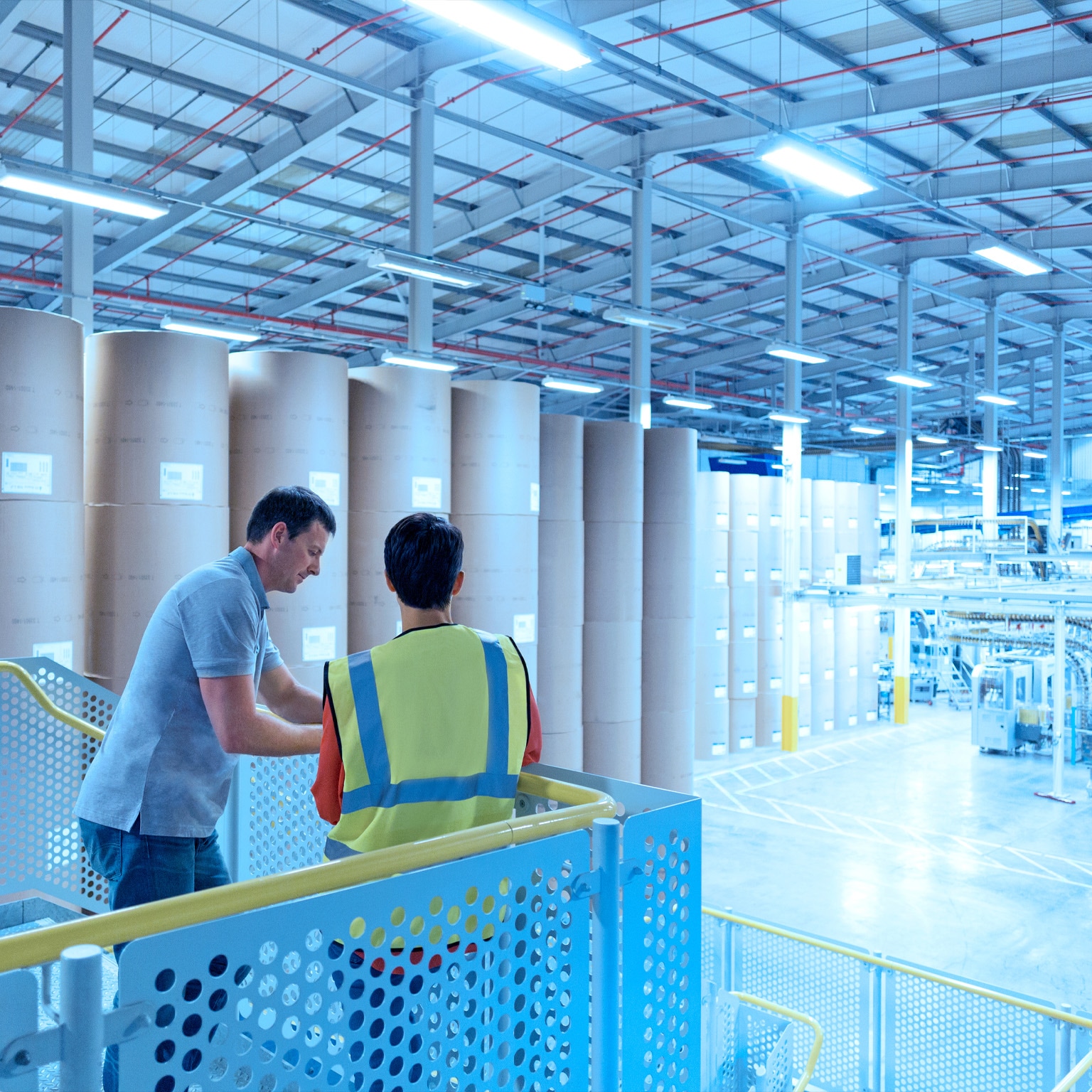 Two men inside a paper factory
