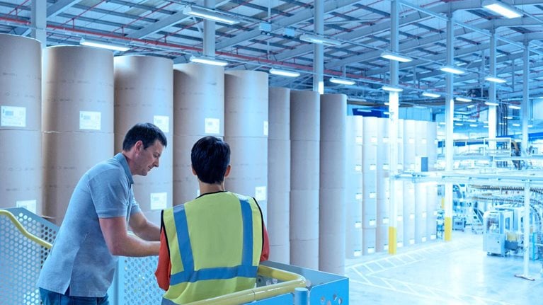 Two men inside a paper factory